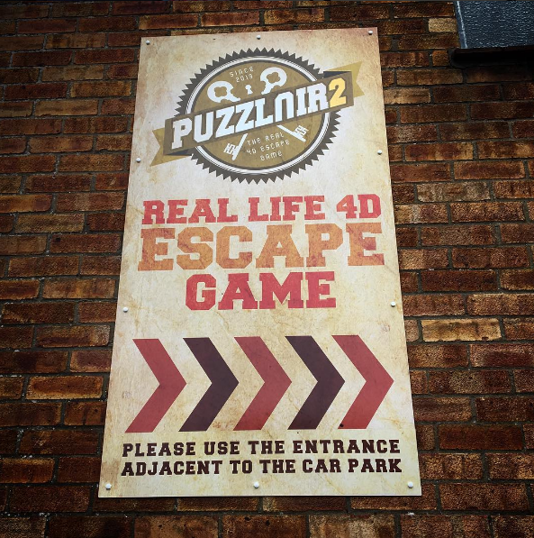 Image of the signage for Puzzlair - a Bristol based escape room adventure